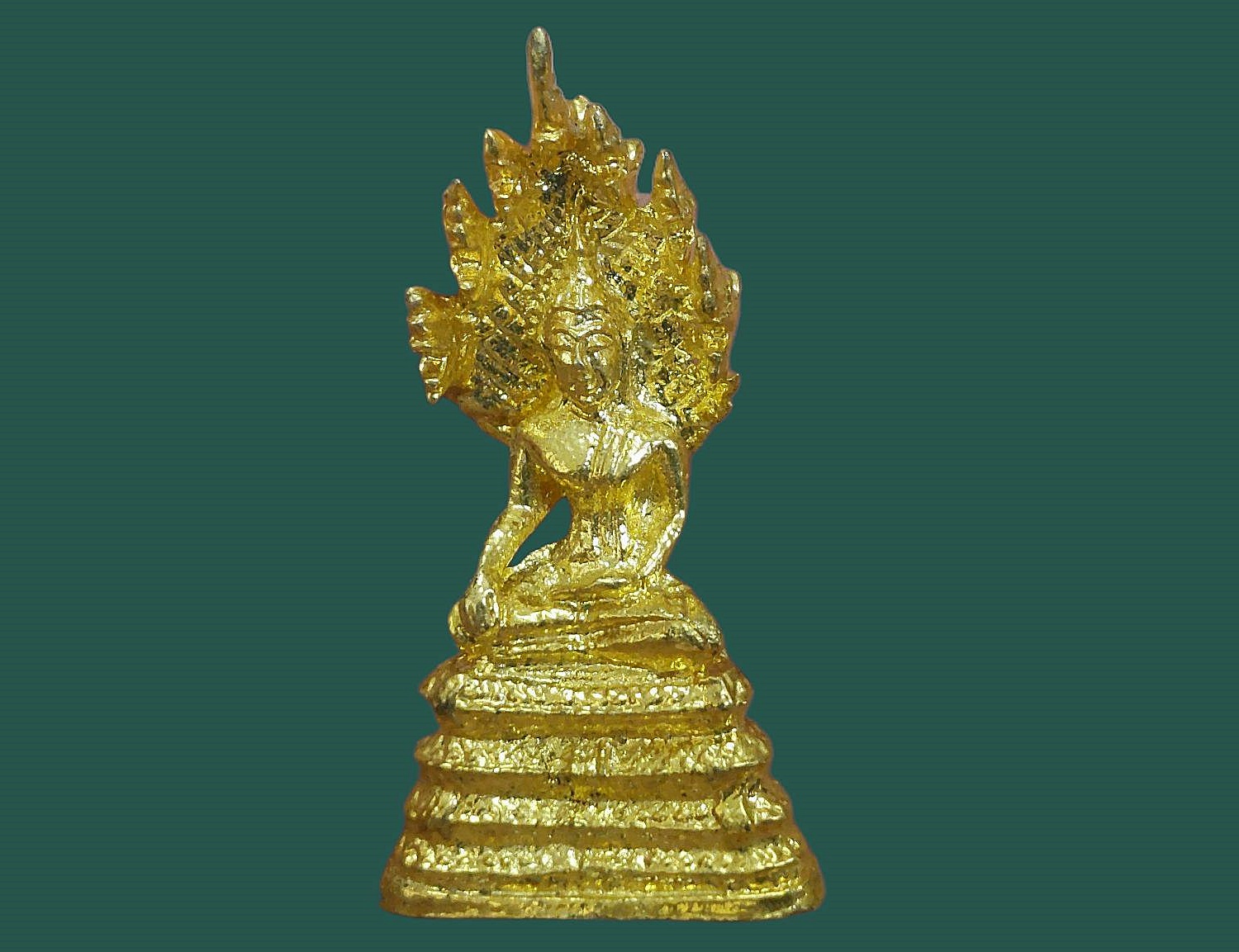 รูปเหมือนกริ่งลอยองค์ พระนาคปรก วัดนาคปรก ภาษีเจริญ จ.กรุงเทพมหานคร เนื้อกะหลั่ยทอง พิมพ์ปรก 7 เศียร